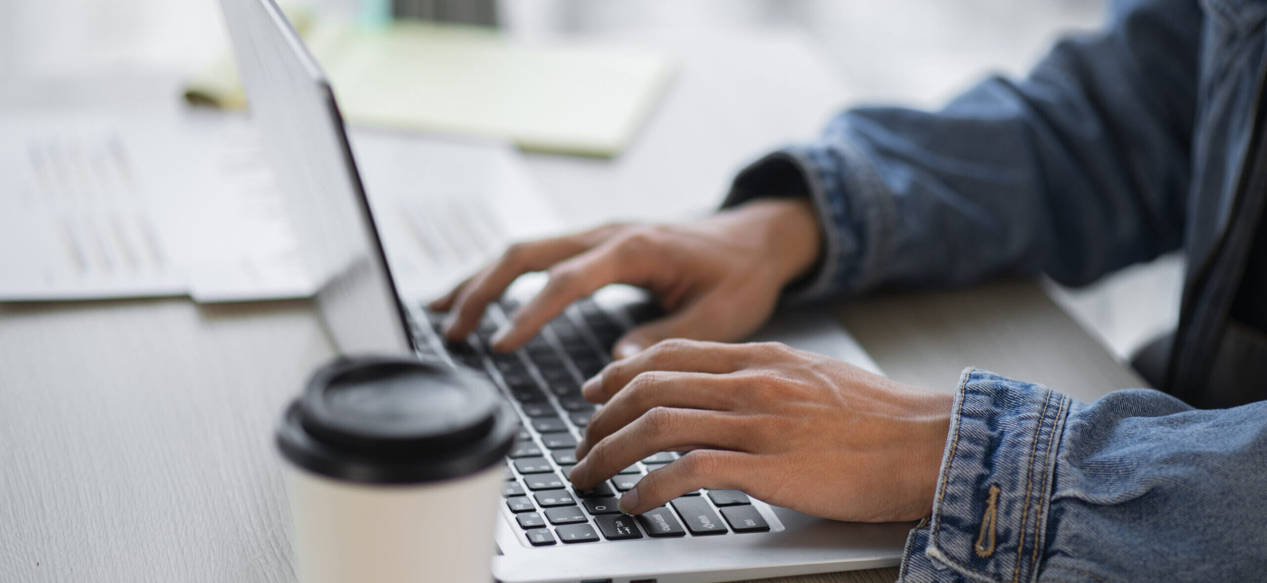A close-up of a person working on a laptop